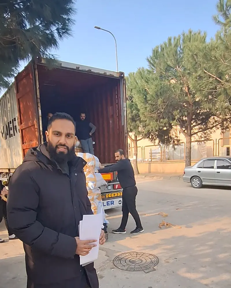 Katfusion team member with shipping documents at a container being loaded